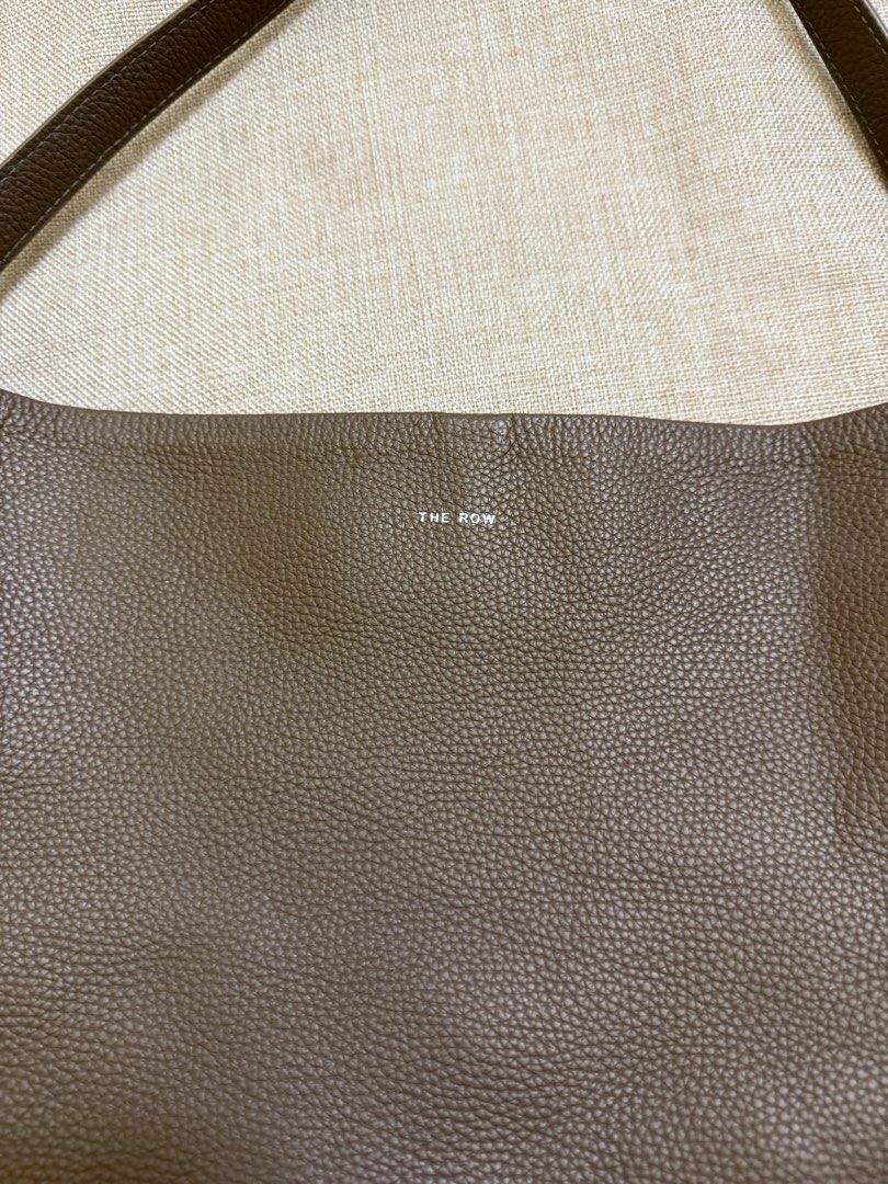 The Row Bucket Bag (Category: Luxury Bags & Wallets) located in San Jose. Submitted by aldieph (Listing ID 1377898071, Image 2). Description: Still in good condition Has signs of usage Ballpen stains interior Thrifted. Pls self-authenticate No Return, no exchange - shop w/ discretion 1995 + SF Courier: J&T Free SF for purchases 2.5k and above 💕 .