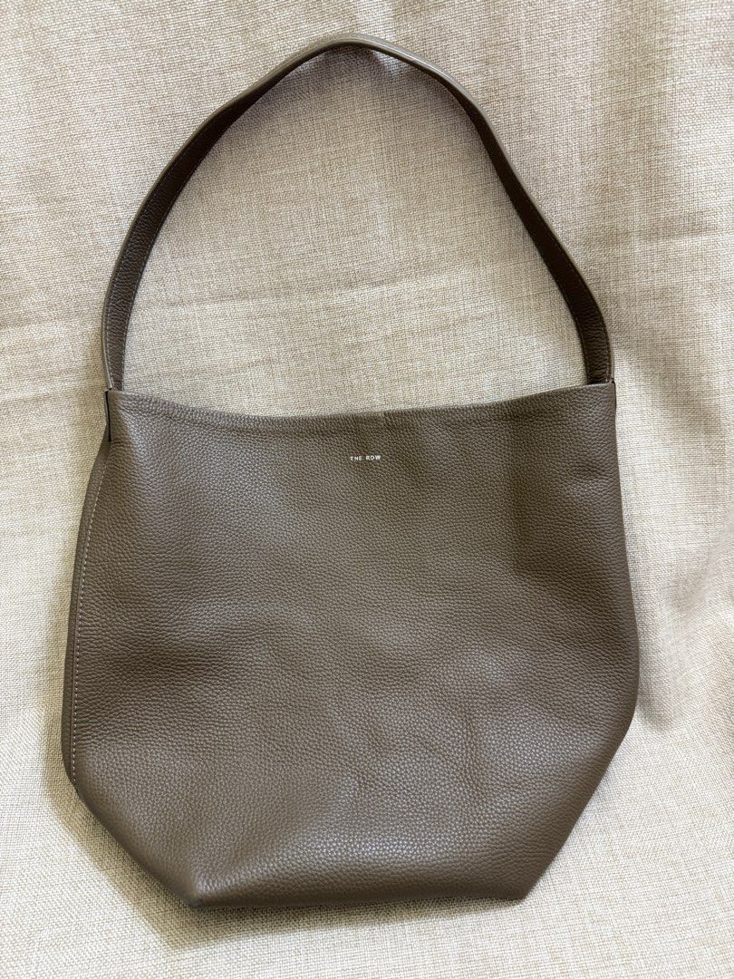 The Row Bucket Bag (Category: Luxury Bags & Wallets) located in San Jose. Submitted by aldieph (Listing ID 1377898071, Image 1). Description: Still in good condition Has signs of usage Ballpen stains interior Thrifted. Pls self-authenticate No Return, no exchange - shop w/ discretion 1995 + SF Courier: J&T Free SF for purchases 2.5k and above 💕 .