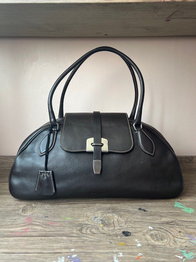 Vintage Prada Leather Boston Bag (Category: Luxury Bags & Wallets) located in Manila. Submitted by ladybagmnl (Listing ID 1377784261, Image 1). Description: Authentic vintage Prada Boston bag in thick pebbled leather with contrast stitching and silver-tone hardware. Deep brown (almost black) color. Rare, structured, and understated—perfect for quiet luxury lovers. 👜 100% AUTHENTIC 👜 Full leather, made in Italy 👜 With original Prada dustbag, cl