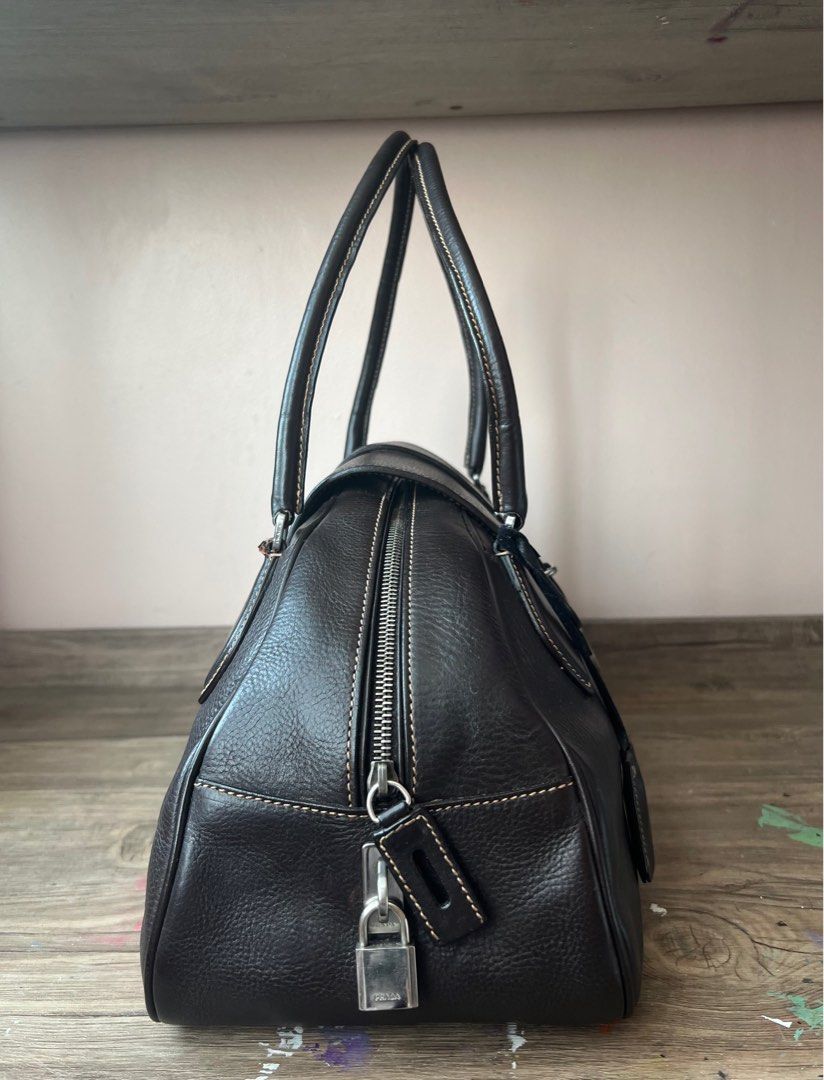 Vintage Prada Leather Boston Bag (Category: Luxury Bags & Wallets) located in Manila. Submitted by ladybagmnl (Listing ID 1377784261, Image 3). Description: Authentic vintage Prada Boston bag in thick pebbled leather with contrast stitching and silver-tone hardware. Deep brown (almost black) color. Rare, structured, and understated—perfect for quiet luxury lovers. 👜 100% AUTHENTIC 👜 Full leather, made in Italy 👜 With original Prada dustbag, cl