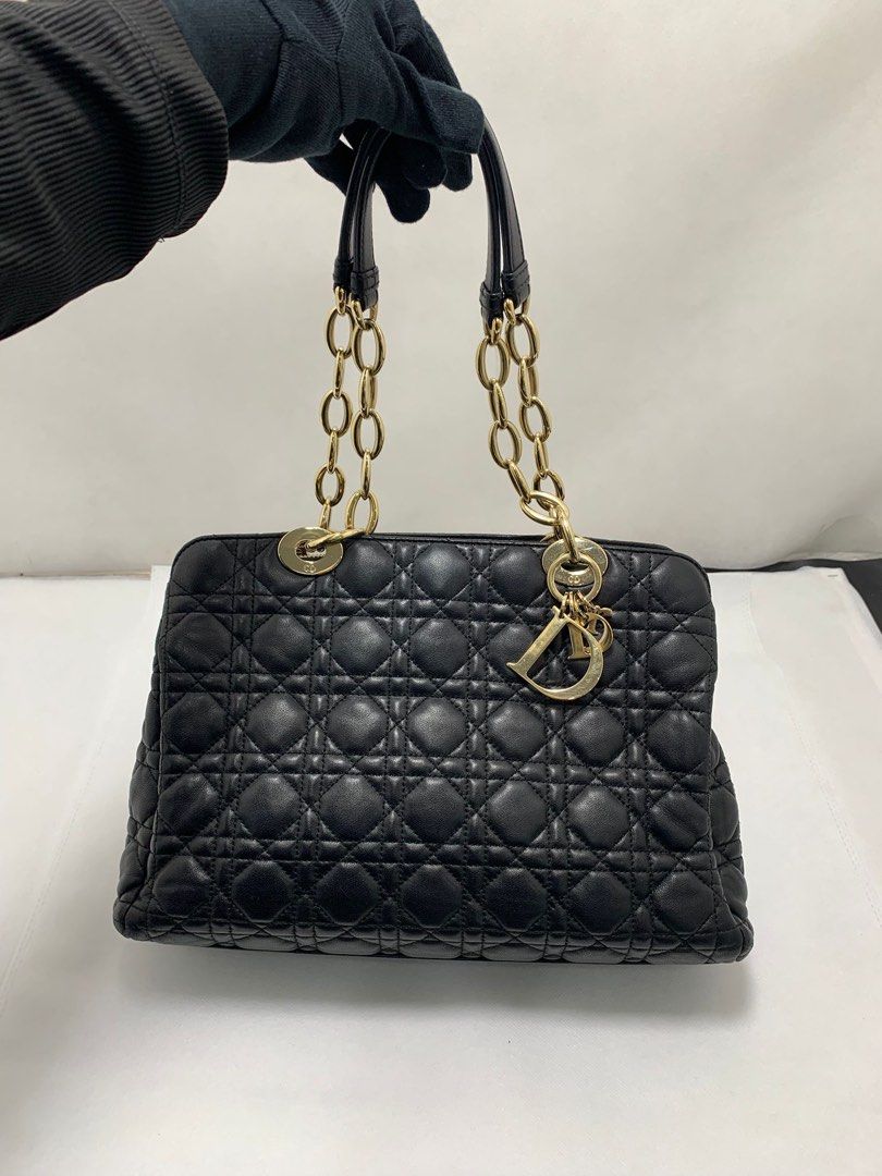 Dior Small Lambskin Cannage Soft Zipped Shopping Tote Bag (Category: Bags & Wallets) located in Singapore. Submitted by sweetpotato99909 (Listing ID 1371964350, Image 2). Description: Classic black quilted leather bag with gold chain detailing. The bag has a double zipper closure and a charm with the Dior logo. Perfect for everyday use or a special occasion. Length 31 cm Width 12 cm Height 23 cm Handle Drop 22.5 cm.