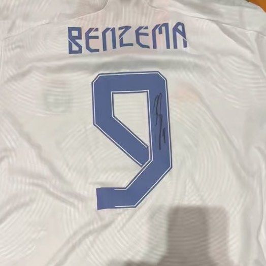 Signed Benzema Real Madrid Jersey (Category: Activewear) located in Singapore. Submitted by chan34235 (Listing ID 1372981149, Image 1). Description: Check out this signed Benzema Real Madrid jersey! It's a must-have for any football fan. The jersey features Benzema's name and number 9 on the back, along with his signature. It's a great piece of memorabilia to add to your collection or to wear to show your support for the team. Don't miss out on t