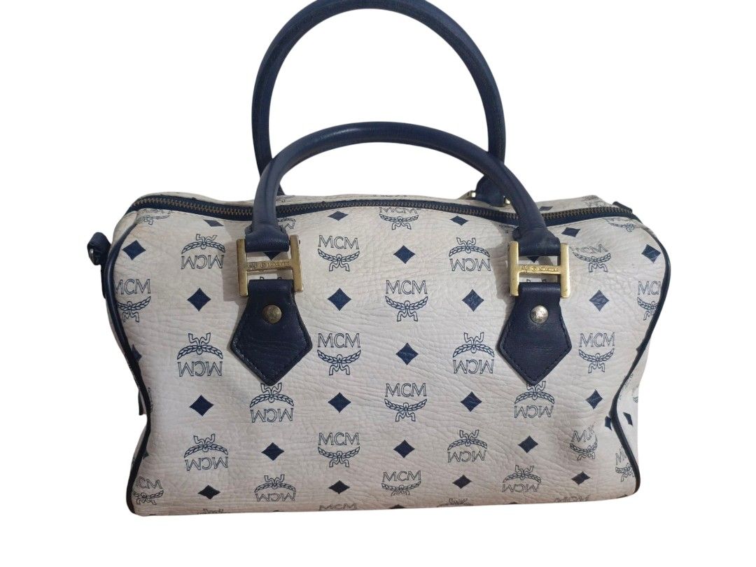 MCM Germany Boston Bag (Category: Luxury Bags & Wallets) located in San Jose del Monte. Submitted by m_nshop (Listing ID 1373175058, Image 2). Description: bawal po ito sa maselan madami na po sign of usage(rubs, not so gold na ang hardwares, may dirt na sa leather) turnable screws po sa meyal plate negotiable and willing to send pics sa serious buyer wala po long strap Japan Source 30cm po jnt courier gcash payment only.