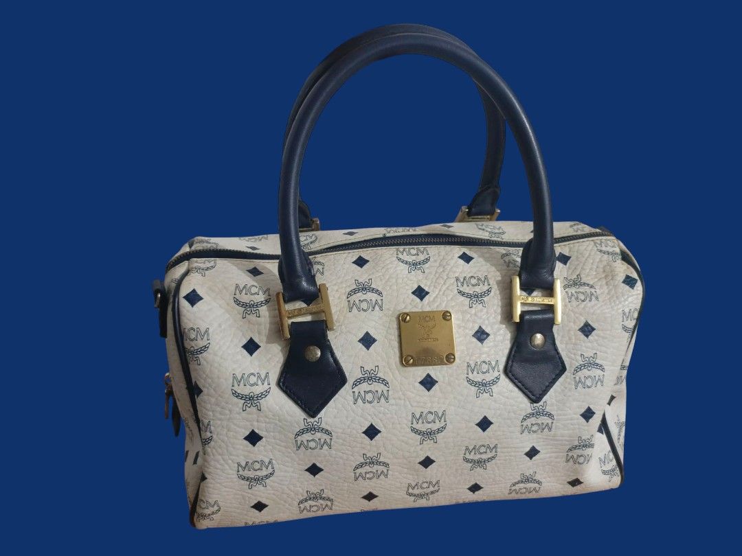 MCM Germany Boston Bag (Category: Luxury Bags & Wallets) located in San Jose del Monte. Submitted by m_nshop (Listing ID 1373175058, Image 1). Description: bawal po ito sa maselan madami na po sign of usage(rubs, not so gold na ang hardwares, may dirt na sa leather) turnable screws po sa meyal plate negotiable and willing to send pics sa serious buyer wala po long strap Japan Source 30cm po jnt courier gcash payment only.