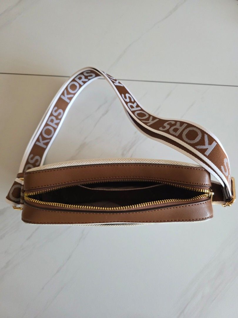 Michael Kors Natural Canva Material Crossbody Bag (Category: Bags & Wallets) located in Singapore. Submitted by cafelattebubble (Listing ID 1373152369, Image 3). Description: Bought from a department store in US. Brand new and never been used. Selling because it cannot fit my folded umbrella, so will suit someone who prefers a compact bag. 23.5cm (L) x 15.5cm (H) x 6cm (W) Comes with bag tag. Has a compartment in front and another compartment ins
