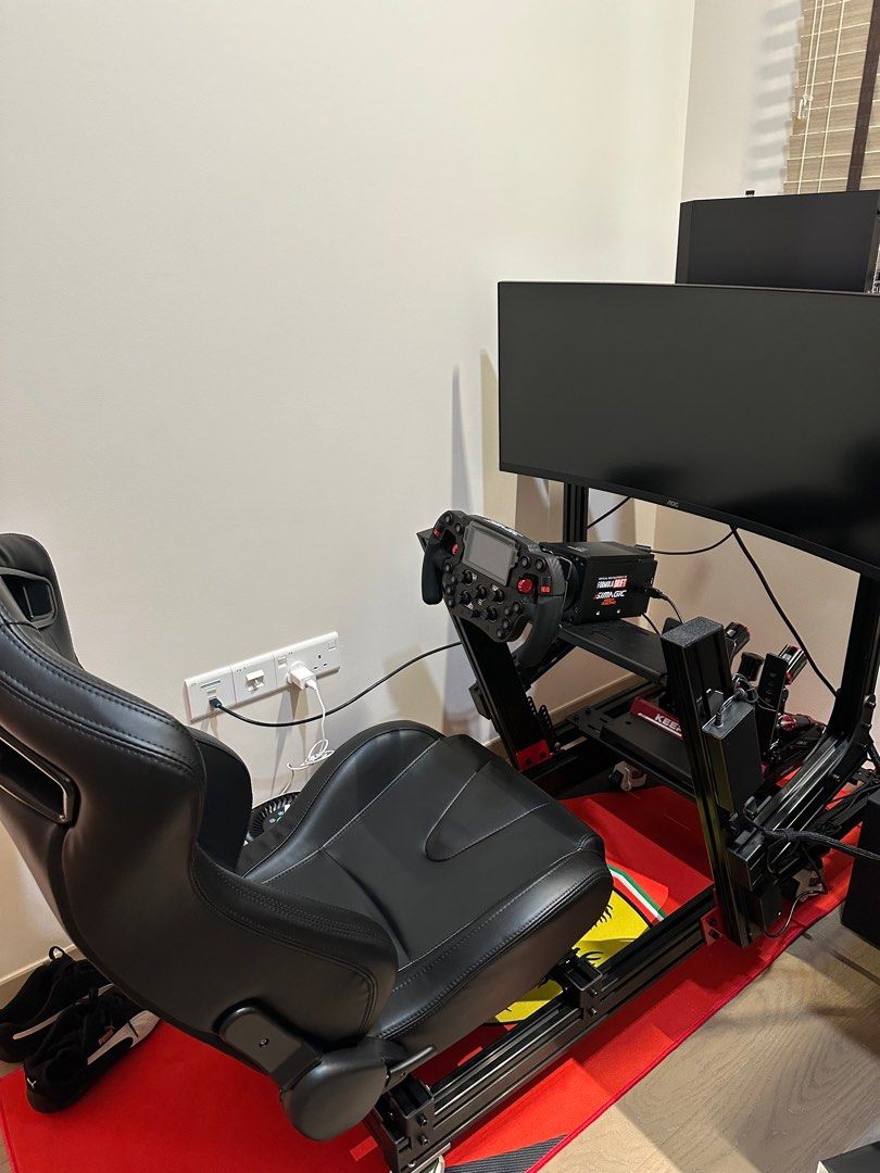 Simagic Full Setup (Category: Controllers) located in Singapore. Submitted by emvmtscooter (Listing ID 1373103388, Image 1). Description: Included components: Simagic Alpha Wheel Base Simagic FX Pro Wheel Simagic P1000 pedal set with heptics Simagic throttle pedal Simagic P-HYS (Hydraulic Brake System) AOC 34” CU34G3X 180Hz Monitor Hisense soundbar with sub woofer Rig with monitor stand, CPU Holder, seat and wheels Connection wires CPU not includ