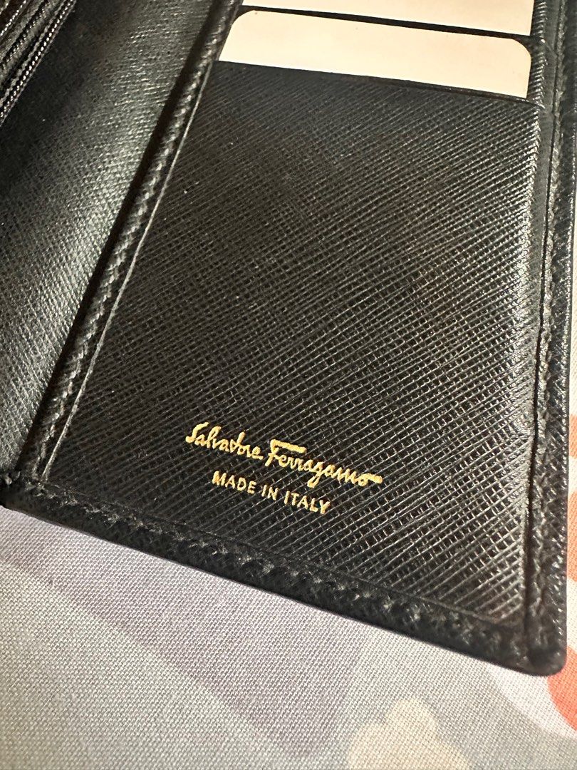 Authentic Ferragamo Long Wallet Black (Category: Luxury Bags & Wallets) located in Muntinlupa City. Submitted by psmolera (Listing ID 1373311340, Image 2). Description: Salvatore Ferragamo Long Black Wallet authentic issue: loosen thread sa ribbon (see last pic) leather well-used in good condition inside 6 card inserts no box, wallet only sf by buyer mop: Gcash/BPI.
