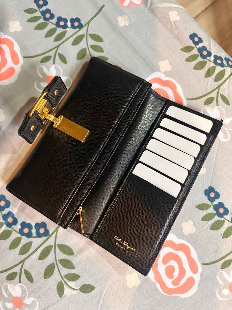 Authentic Ferragamo Long Wallet Black (Category: Luxury Bags & Wallets) located in Muntinlupa City. Submitted by psmolera (Listing ID 1373311340, Image 3). Description: Salvatore Ferragamo Long Black Wallet authentic issue: loosen thread sa ribbon (see last pic) leather well-used in good condition inside 6 card inserts no box, wallet only sf by buyer mop: Gcash/BPI.