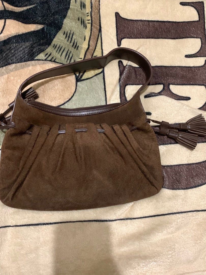 Authentic Givenchy Suede Leather Shoulder Bag (Category: Luxury Bags & Wallets) located in Manila. Submitted by girlwithatattoo (Listing ID 1373342883, Image 3). Description: The exterior is Suede Has Gold Tone Hardware Drawstring (leather) tassel accents Vintage & Preloved Price is negotiable ‼️ Can do meet up around lrt line 2, around sm manila or city hall, lalamove/grab, or J&T. .
