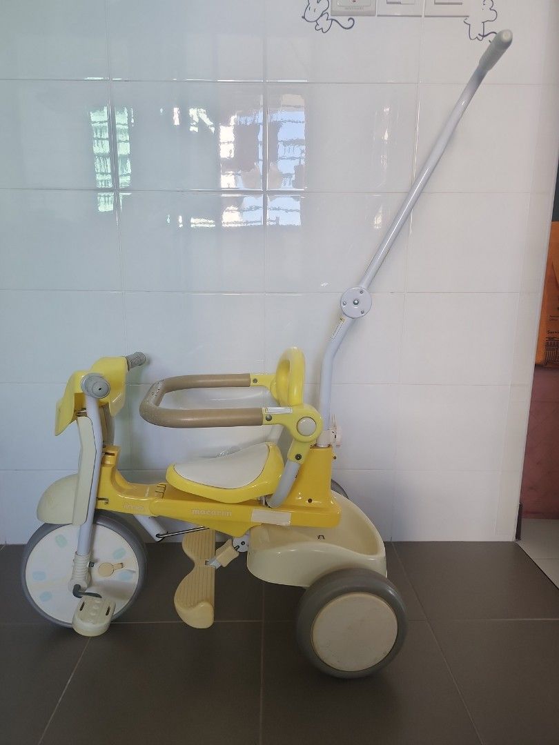 Iimo Foldable Tricycle (Category: Other Babies Going Out Needs) located in Singapore. Submitted by ohoka78 (Listing ID 1373379128, Image 3). Description: Item in usable condition but with obvious wear and tear such as cracked rubber and stickers peeling. The steering handle bar for parents is not functioning well as the connecting part (see last 2 pic) between the front wheel and the steering handle can come off if turn too wide. Definitely not f