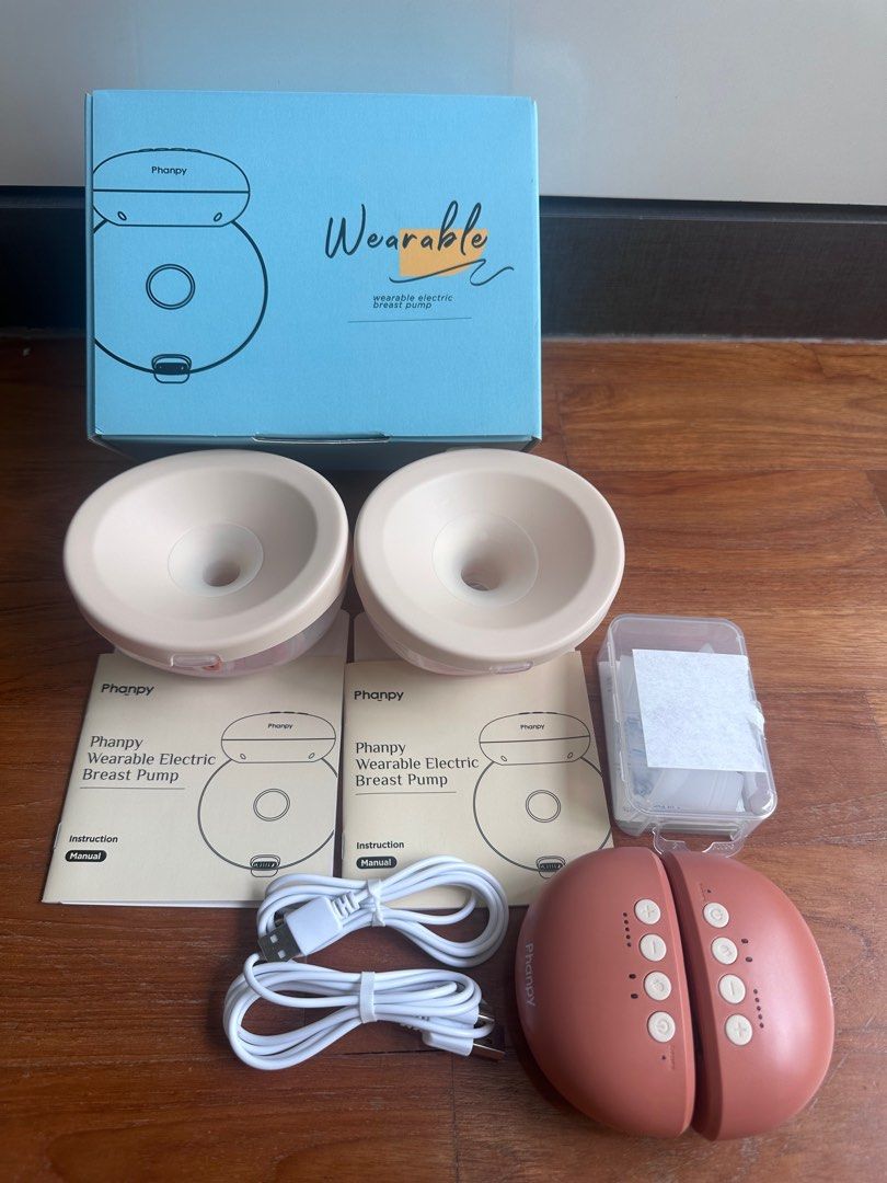 Phanpy Wearable Electric Breast Pump (Category: Breastfeeding & Bottle Feeding) located in Singapore. Submitted by tellyouwhat (Listing ID 1373255011, Image 1). Description: This is my spare set of the same wearable electric breast pump, as the initial set was used for many years; had this as standby. Comes with: - Box - Manuals - Original charging cables (unused) - Milk containers with all original pump parts intact - 2 x electric pumps - FOC: B