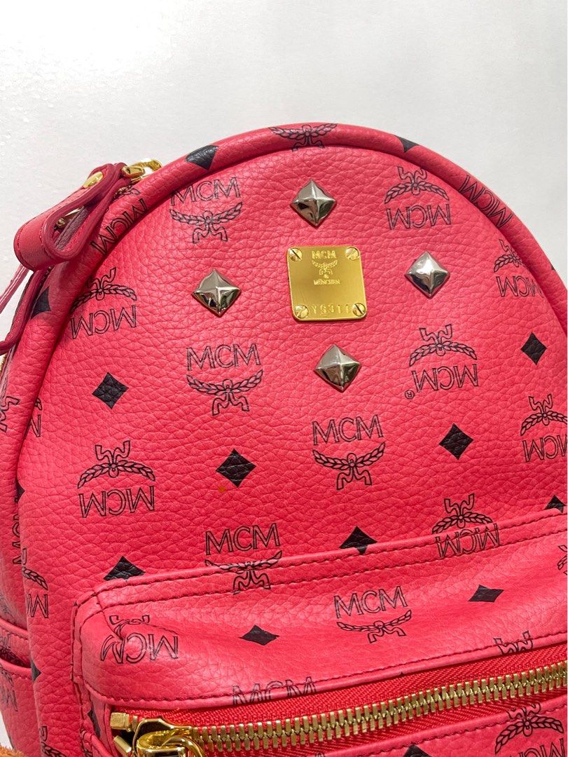 Authentic 💯 MCM Stark Pink Backpack Bag (with stud) (Category: Luxury Bags & Wallets) located in Quezon City. Submitted by declutterbybd (Listing ID 1373516434, Image 3). Description: 100% Authenticity Guaranteed! (Like New) Pre-loved. Used it twice only! On Hand! Bought directly in Korea. Money Back if proven fake (Big price markdown , really need to declutter) Item Details: *Model: MCM Stark Studded Backpack Bag *Color: Pinkish red *Size: Medi