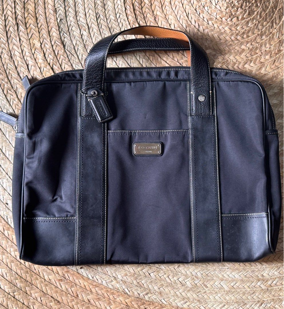 Coach Briefcase (Category: Briefcases) located in Lucban. Submitted by jakobv (Listing ID 1373430922, Image 1). Description: 9.8/10 This elegant briefcase is crafted from durable nylon with refined leather accents, combining functionality with a sleek, professional look. It shows very minimal signs of use and remains in pristine overall condition. Both the interior and exterior are exceptionally clean, with no major scuffs, stains, or marks. Idea