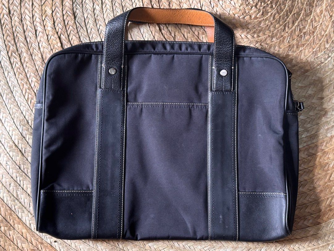 Coach Briefcase (Category: Briefcases) located in Lucban. Submitted by jakobv (Listing ID 1373430922, Image 2). Description: 9.8/10 This elegant briefcase is crafted from durable nylon with refined leather accents, combining functionality with a sleek, professional look. It shows very minimal signs of use and remains in pristine overall condition. Both the interior and exterior are exceptionally clean, with no major scuffs, stains, or marks. Idea