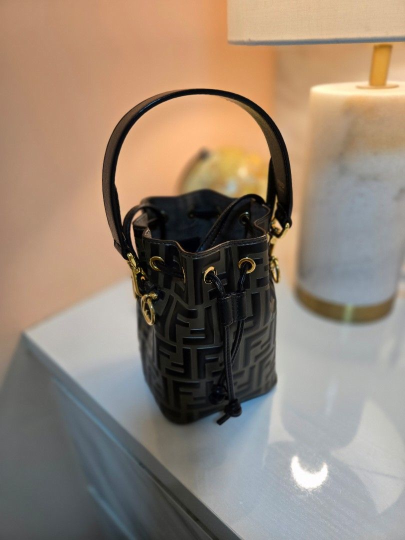 Fendi Mon Tresor (Category: Bags & Wallets) located in Singapore. Submitted by demadhatterr (Listing ID 1373514592, Image 1). Description: Small Mon Tresor bucket bag made of brown calfskin embossed and hand-painted with the FF motif in black. Lined and with gold-finish metalware. Featuring two detachable shoulder straps, one long and one short, to wear the bag over the shoulder or cross-body. Holds a 6.2-inch smartphone, Mini Trifold card holder