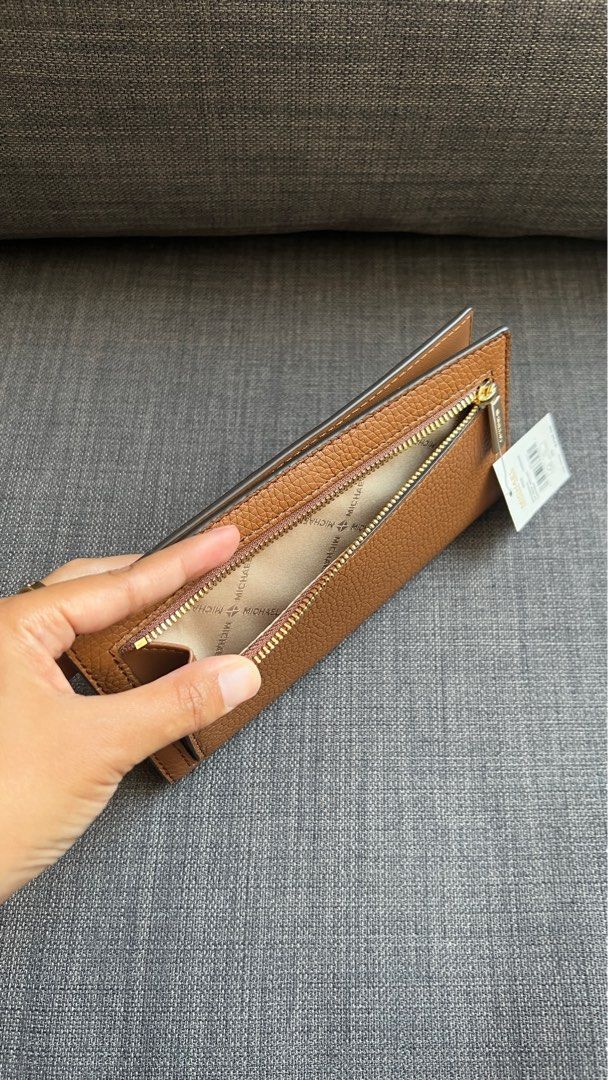 Michael Kors Reed Large Pebbled Leather Wallet (Brown) (Category: Wallets & Card holders) located in San Jose del Monte. Submitted by mishfcr (Listing ID 1373461126, Image 2). Description: Brand new and guaranteed authentic from the US 🇺🇸 MK Reed Large Pebble Leather Wallet in Brown Retails for $298 plus tax Selling for P2990 only • Pebbled leather • 100% leather • Gold-tone hardware • 7.5”W X 4”H X 0.75”D • Exterior details: back zip pocket • 