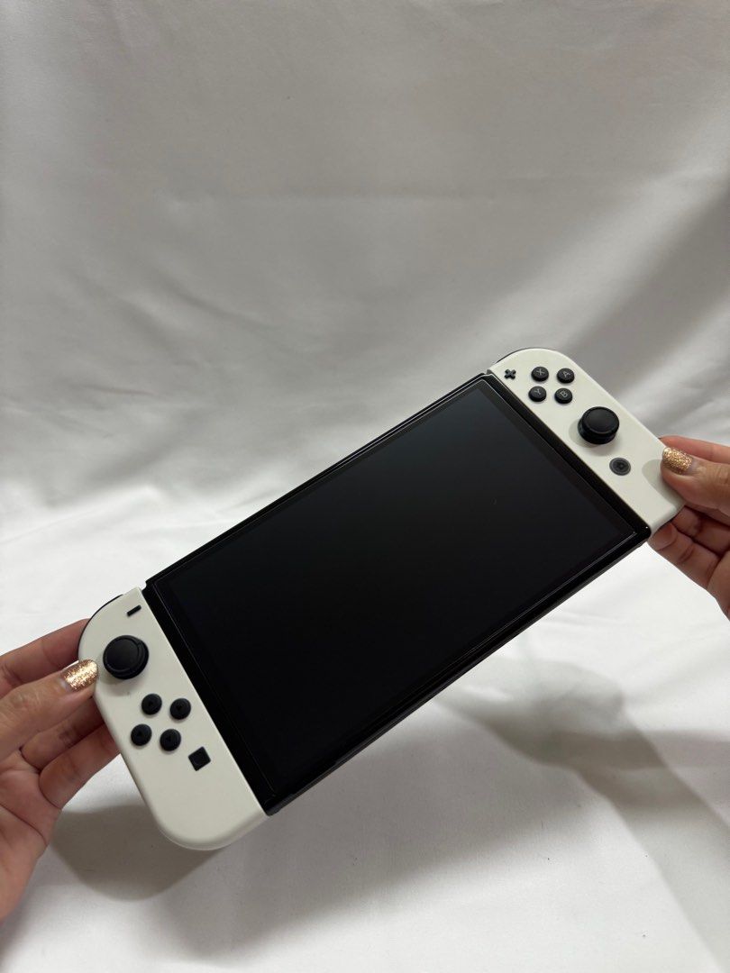 Nintendo Switch - OLED White Model with case (Category: Nintendo) located in Mandaluyong City. Submitted by secondchanceshop.mnl (Listing ID 1373437841, Image 3). Description: Freebies: Switch case (Pikachu) - bought at Php260 Full storage case (Mario) - bought at Php 500 Extra tempered glass (unit also has an installed tempered glass) Pristine condition. Barely used. Bought Aug 2024. .