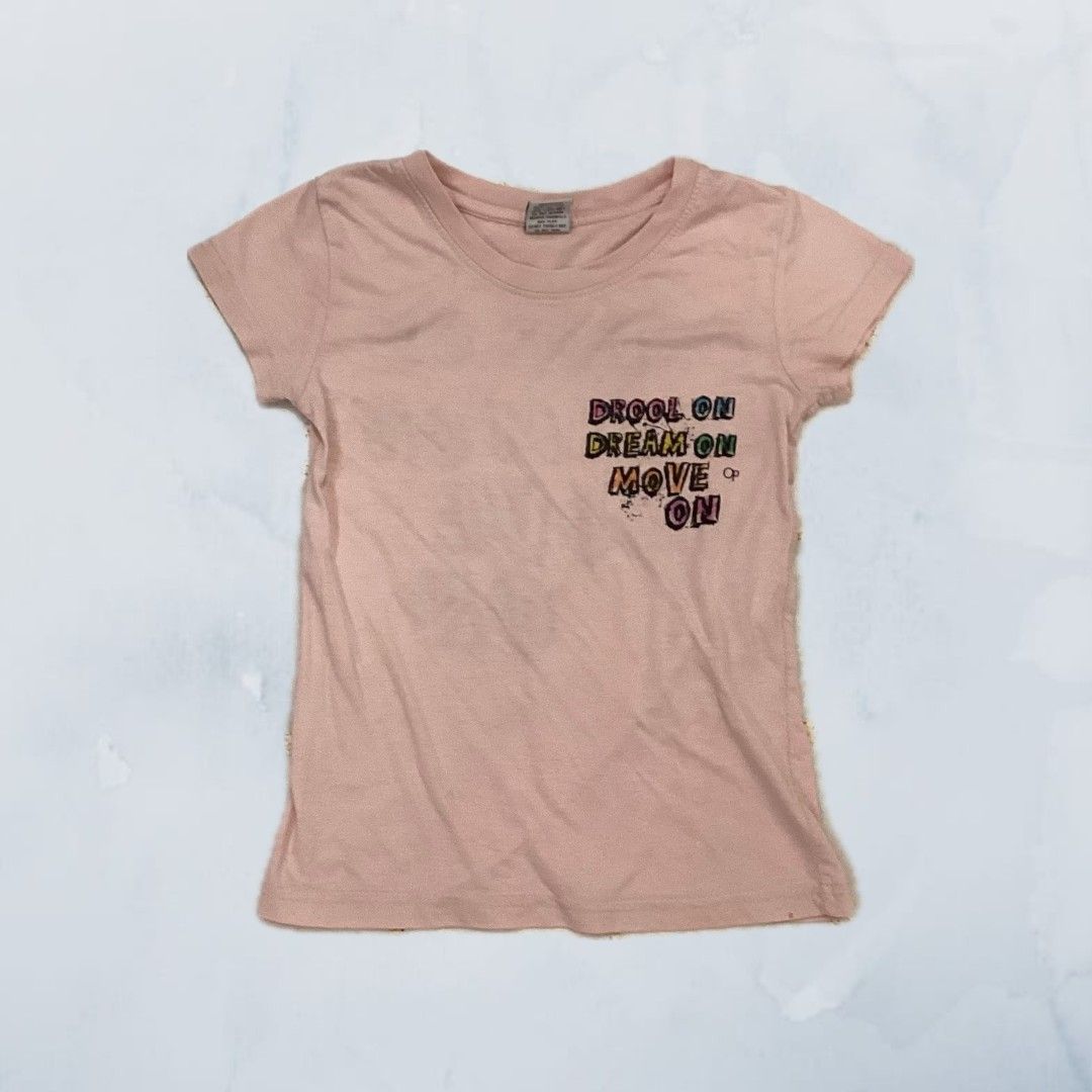 Pink T-shirt (Category: Babies & Kids Fashion) located in Singapore. Submitted by bellezapparel (Listing ID 1373665052, Image 1). Description: The size is 6/7, shirt is in good condition other than small stain at the bottom 📮mailing is available for $3.