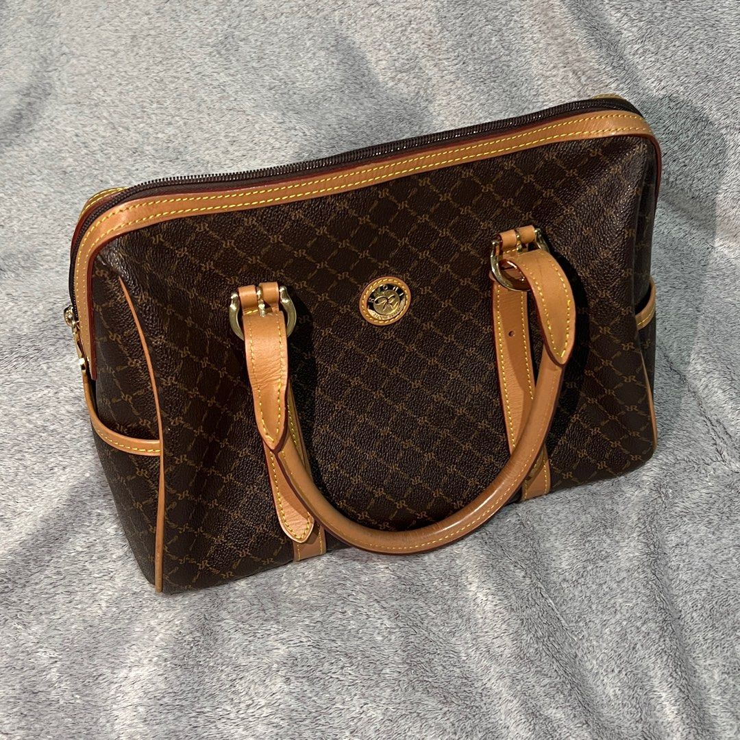 rioni the michigan carrier (Category: Luxury Bags & Wallets) located in Manila. Submitted by acxc01 (Listing ID 1373681833, Image 1). Description: ♡ premium rioni signature monogram canvas ♡ top zip closure for secure storage ♡ soft fabric-lined interior with multiple compartment ♡ timeless design – perfect for work, school, or travel.