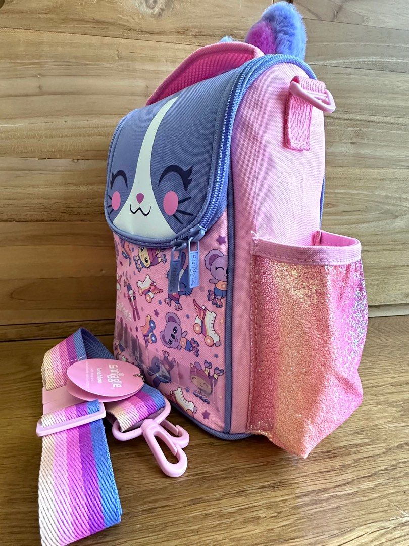 Smiggle lunchbox with strap (Category: Babies & Kids Fashion) located in Singapore. Submitted by dwnyew (Listing ID 1373624470, Image 3). Description: Brand new with tag Without customized Id card Fluffy bunny ears Self collect from Paya lebar mrt on weekend .