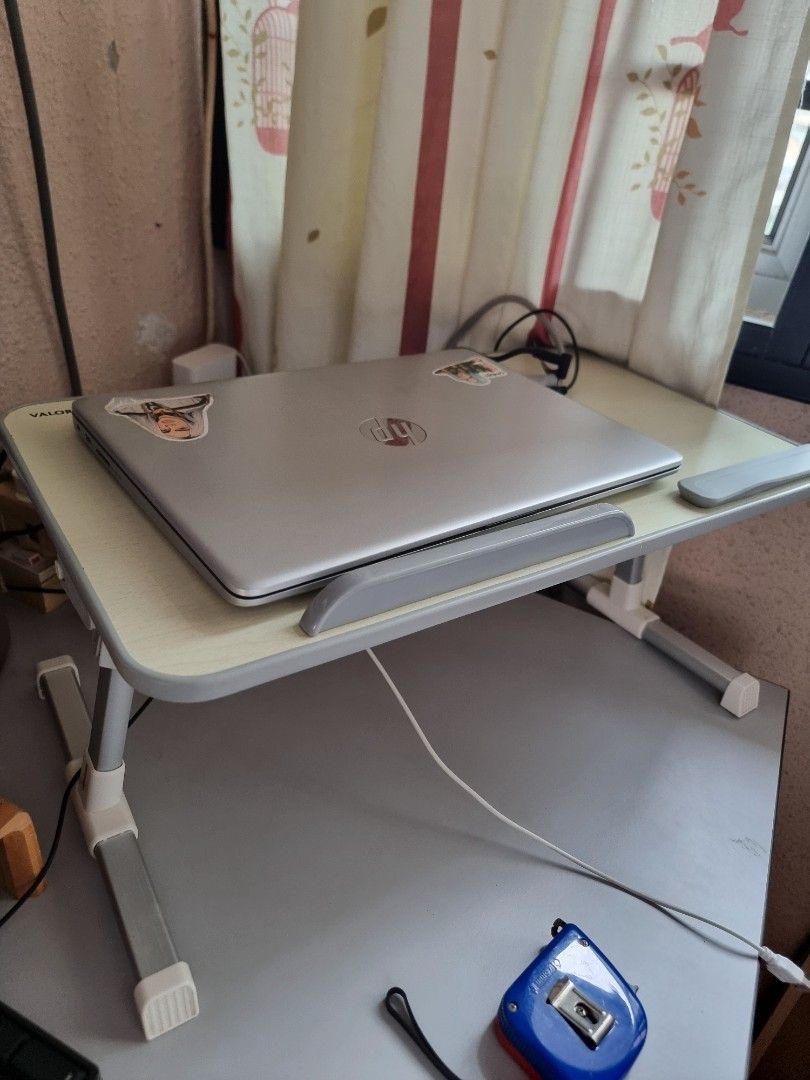 Valore Laptop stand with fan cooler (Foldable & adjustable) (Category: Other Accessories) located in Singapore. Submitted by swenamon (Listing ID 1373677303, Image 2). Description: Looks like a little old as been used for a long time, but it's very good in terms of mechanics and functionality. FYI: VERY good wood. Valore brand. Has an installed fan cooler. No packaging, and no more work from home, so selling away for cheap. Adjustable height and 