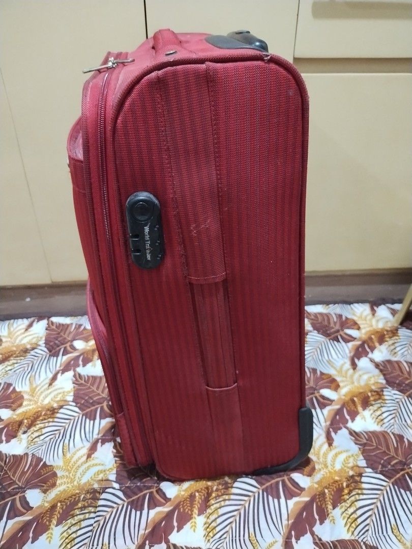 World Traveller medium size luggage (Category: Luggage) located in Makati City. Submitted by chamarket.2022 (Listing ID 1373688089, Image 3). Description: features: 1. depth: 8 inches 2. height: 23 inches; 23.5 inches with wheels 3. width: 15 inches 4. softcase 5. built-in lock 6. 2-wheels 7. medium size 8. multiple pockets/ compartments flaws are scratches, torn inside pocket, and needs cleaning. Refer to the picture. buyer need to be shouldered