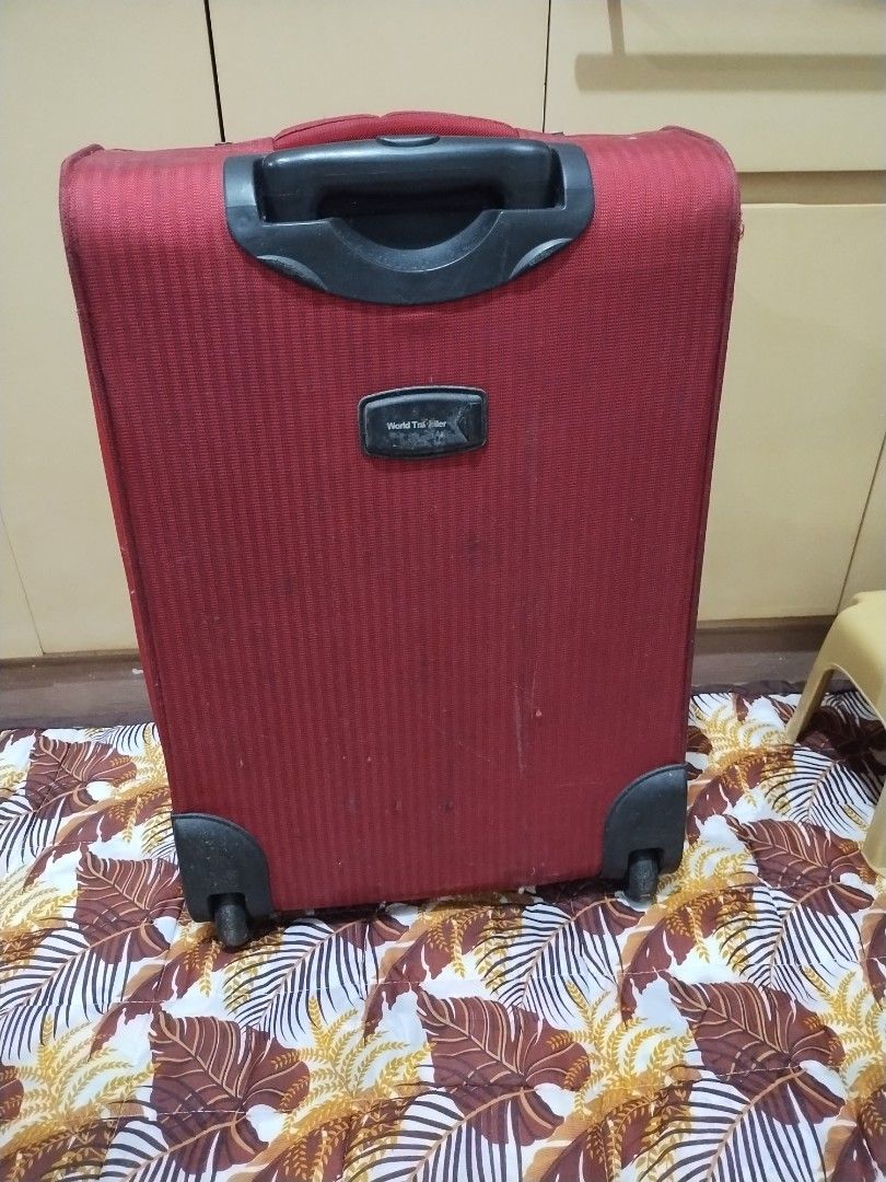 World Traveller medium size luggage (Category: Luggage) located in Makati City. Submitted by chamarket.2022 (Listing ID 1373688089, Image 2). Description: features: 1. depth: 8 inches 2. height: 23 inches; 23.5 inches with wheels 3. width: 15 inches 4. softcase 5. built-in lock 6. 2-wheels 7. medium size 8. multiple pockets/ compartments flaws are scratches, torn inside pocket, and needs cleaning. Refer to the picture. buyer need to be shouldered