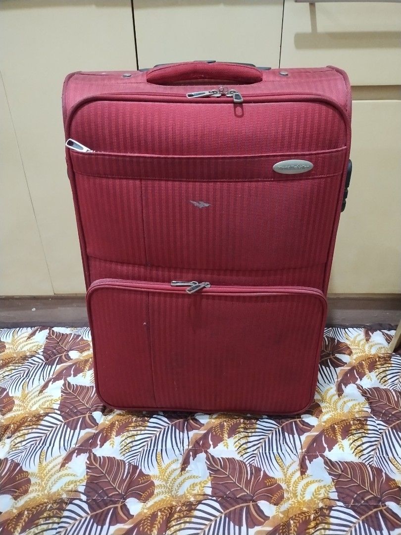World Traveller medium size luggage (Category: Luggage) located in Makati City. Submitted by chamarket.2022 (Listing ID 1373688089, Image 1). Description: features: 1. depth: 8 inches 2. height: 23 inches; 23.5 inches with wheels 3. width: 15 inches 4. softcase 5. built-in lock 6. 2-wheels 7. medium size 8. multiple pockets/ compartments flaws are scratches, torn inside pocket, and needs cleaning. Refer to the picture. buyer need to be shouldered
