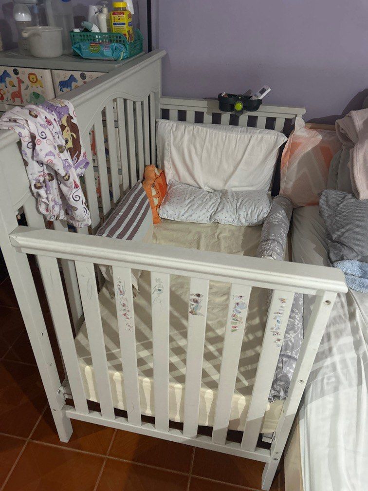Cuddle bug crib (Category: Cots & Cribs) located in Manila. Submitted by warnerjason.co (Listing ID 1373926867, Image 1). Description: - with matress - bottle holder - can be used as a crib or co sleeper - lightly used as our daughter does not want to sleep on it. - with drawings and stickers on it as played with by a toddler but can be painted - buyer to arrange transport or delivery - still in good and very safe condition.