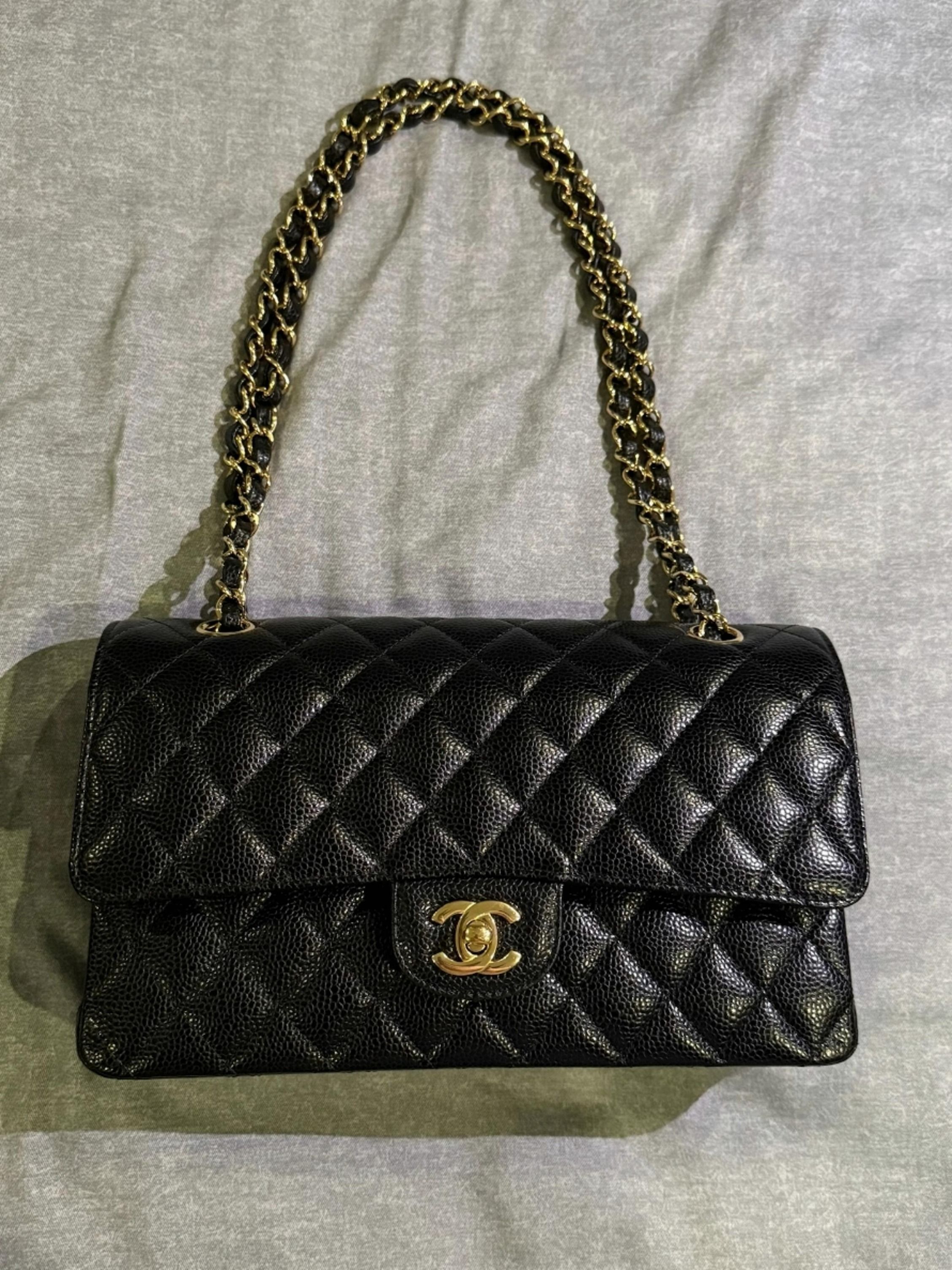 Chanel Caviar Classic Flap Medium CF GHW Full Set (Category: Bags & Wallets) located in Singapore. Submitted by prosperow (Listing ID 1378022628, Image 1). Description: Chanel Classic Flap bag in black caviar leather. Features a gold chain strap and iconic CC turn-lock closure. The interior is lined with burgundy leather. Still in good condition. A timeless piece!.