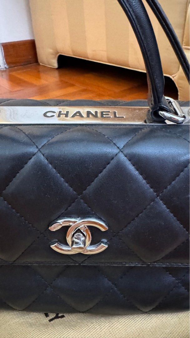 Chanel Quilted Top Handle Bag (Vintage) (Category: Bags & Wallets) located in Singapore. Submitted by therealistsg (Listing ID 1378085412, Image 2). Description: Authentic Chanel top handle bag in black. Features a quilted design with the iconic CC logo. The bag shows signs of wear, including some scuffing on the corners and hardware. Interior is clean. Selling as is. Belonged to a family member. The bag was produced around 2014–2015, based on Ch