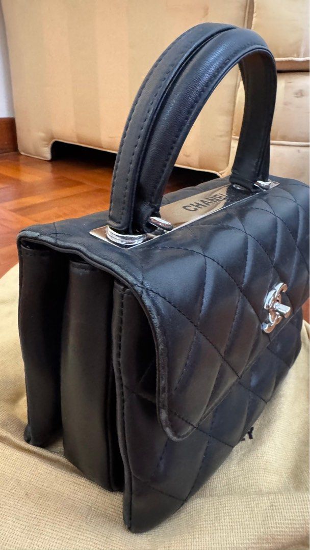 Chanel Quilted Top Handle Bag (Vintage) (Category: Bags & Wallets) located in Singapore. Submitted by therealistsg (Listing ID 1378085412, Image 3). Description: Authentic Chanel top handle bag in black. Features a quilted design with the iconic CC logo. The bag shows signs of wear, including some scuffing on the corners and hardware. Interior is clean. Selling as is. Belonged to a family member. The bag was produced around 2014–2015, based on Ch