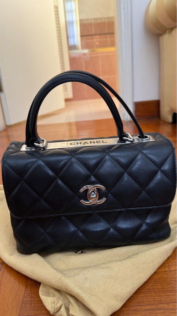 Chanel Quilted Top Handle Bag (Vintage) (Category: Bags & Wallets) located in Singapore. Submitted by therealistsg (Listing ID 1378085412, Image 1). Description: Authentic Chanel top handle bag in black. Features a quilted design with the iconic CC logo. The bag shows signs of wear, including some scuffing on the corners and hardware. Interior is clean. Selling as is. Belonged to a family member. The bag was produced around 2014–2015, based on Ch