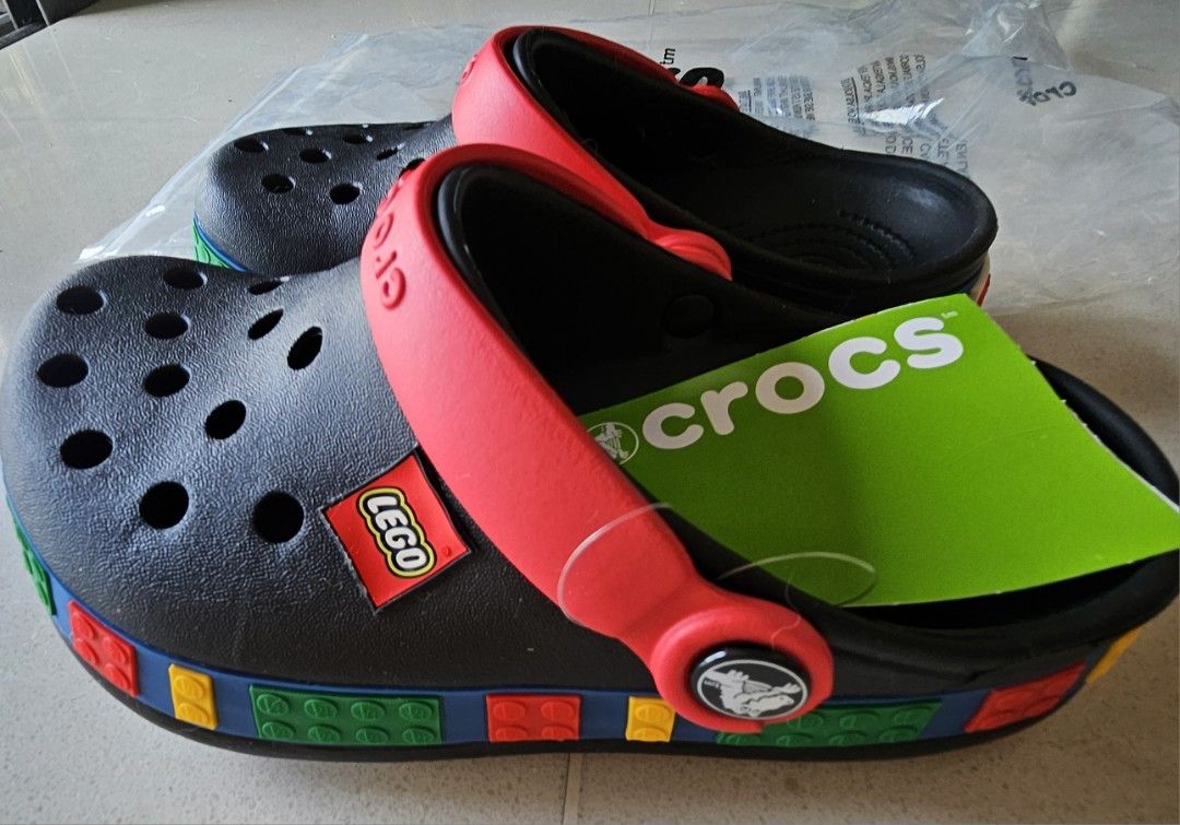 Crocs LEGO Classic Clogs - Brand New (Category: Babies & Kids Fashion) located in Singapore. Submitted by colorfulcloud (Listing ID 1378007458, Image 3). Description: - Brand new Crocs Classic Clogs - LEGO collaboration - Kids size. Crocs US size J1. Suitable for around 20 cm long foot. Depending on your kid's feet size, likely suitable for 7 to 8 years old. - Black base - Red straps - Colorful LEGO brick detailing - Includes original tags and pa