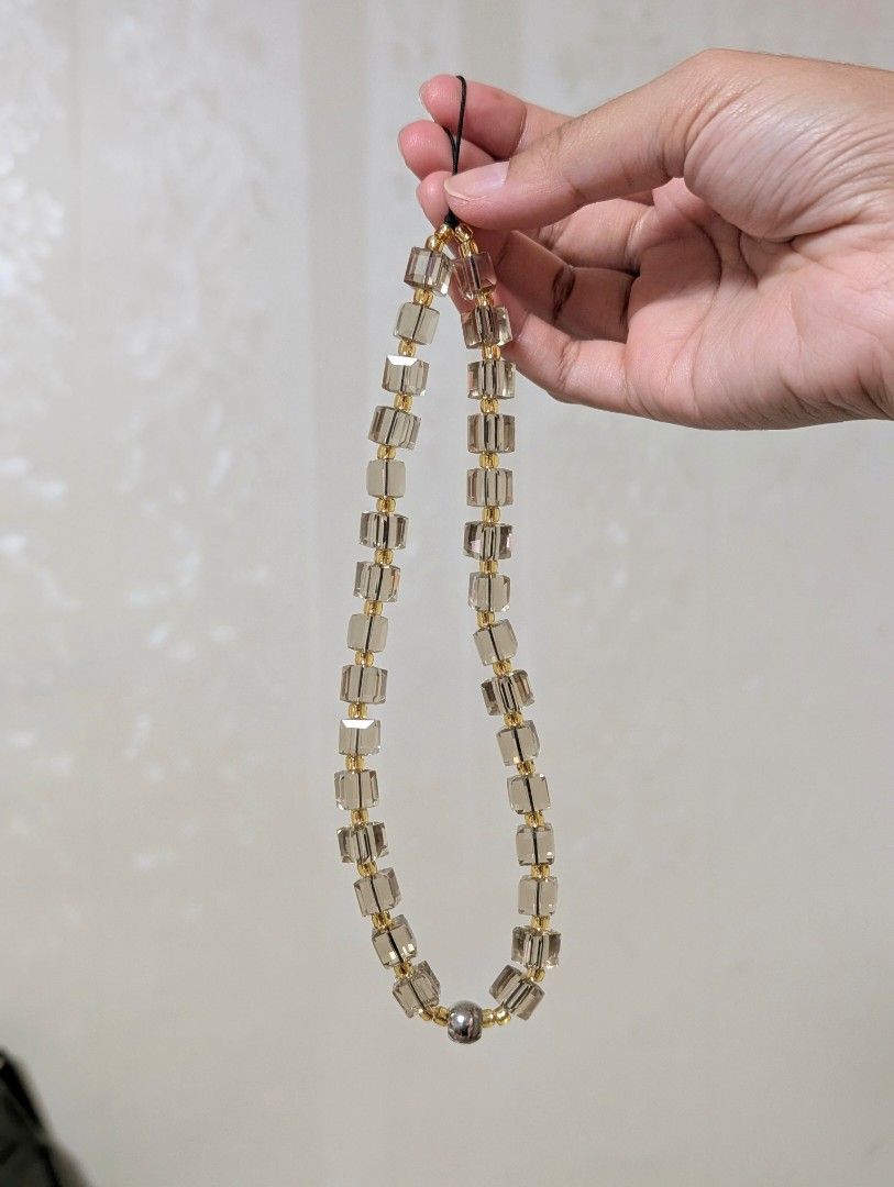 Crystal Phone Charm - champagne gold (Category: Other Mobile & Gadget Accessories) located in Valenzuela. Submitted by neromiii (Listing ID 1366224159, Image 3). Description: Made with imported Austrian crystals and Japanese delica beads, hindi pipitsuging beads Shines like Swarovski✨ String Ting inspired Can be used as phone charm or bag charm.