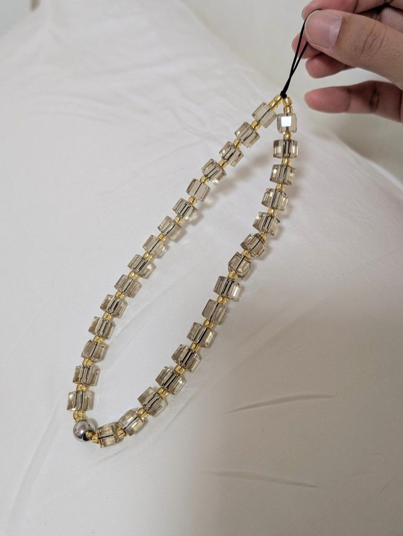 Crystal Phone Charm - champagne gold (Category: Other Mobile & Gadget Accessories) located in Valenzuela. Submitted by neromiii (Listing ID 1366224159, Image 1). Description: Made with imported Austrian crystals and Japanese delica beads, hindi pipitsuging beads Shines like Swarovski✨ String Ting inspired Can be used as phone charm or bag charm.