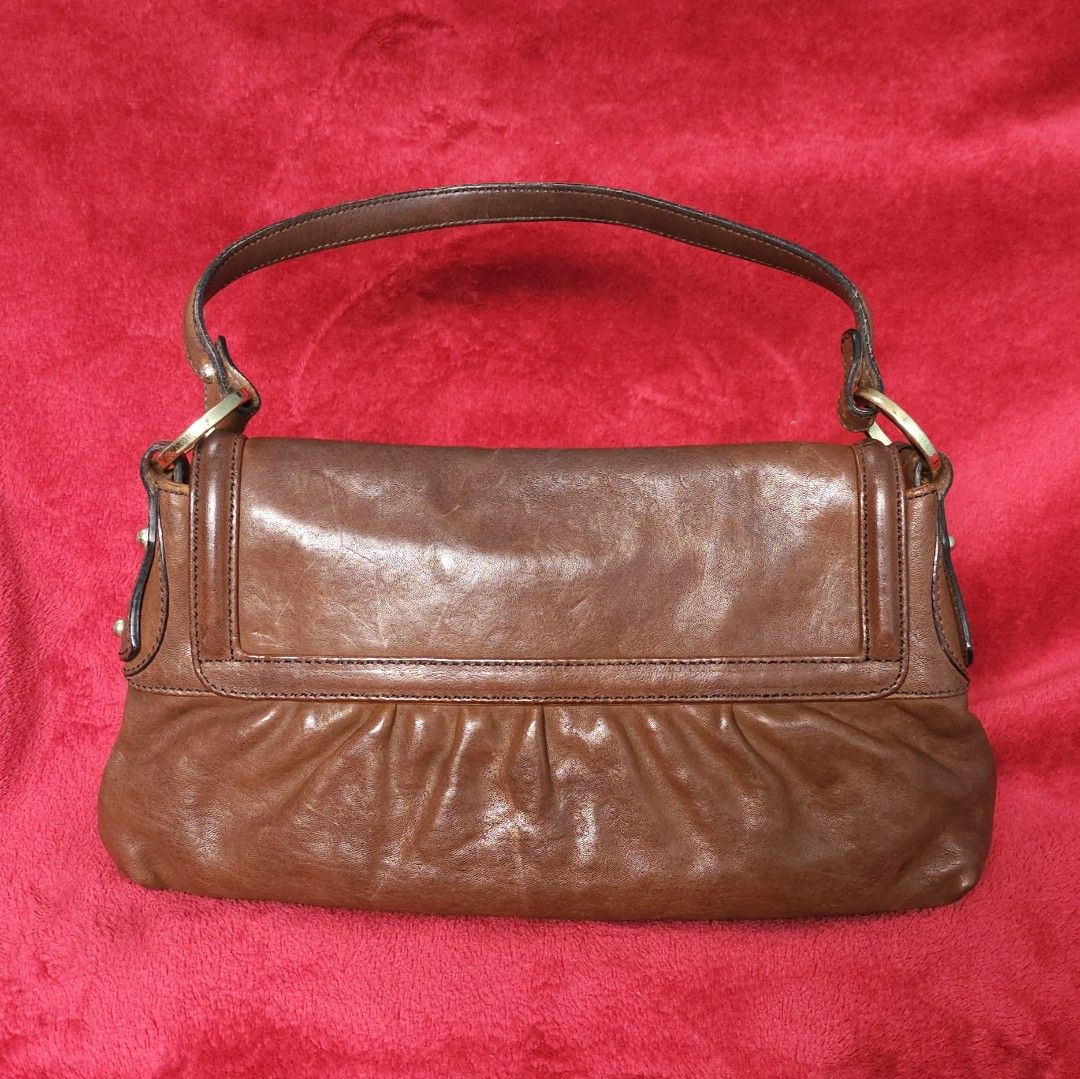 Fendi Brown Leather Chef Baguette Dark brown (Category: Luxury Bags & Wallets) located in Paranaque City. Submitted by judith.uy (Listing ID 1377974915, Image 2). Description: Guaranteed 💯 original preloved from Japan, minor signs of use No rubs, straps are intact, hardware has slight hairline scratches With free authentication available for meetup or buyer will shoulder shipping slightly negotiable.