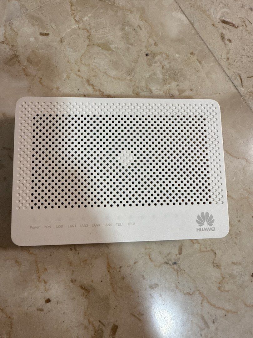 Huawei Router (Category: Networking) located in Singapore. Submitted by priscilla___ (Listing ID 1378096410, Image 1). Description: White Huawei router. Features multiple LAN and TEL ports. The device has a perforated top for ventilation and a Huawei logo on the right side. Includes power, PON, LOS indicators..