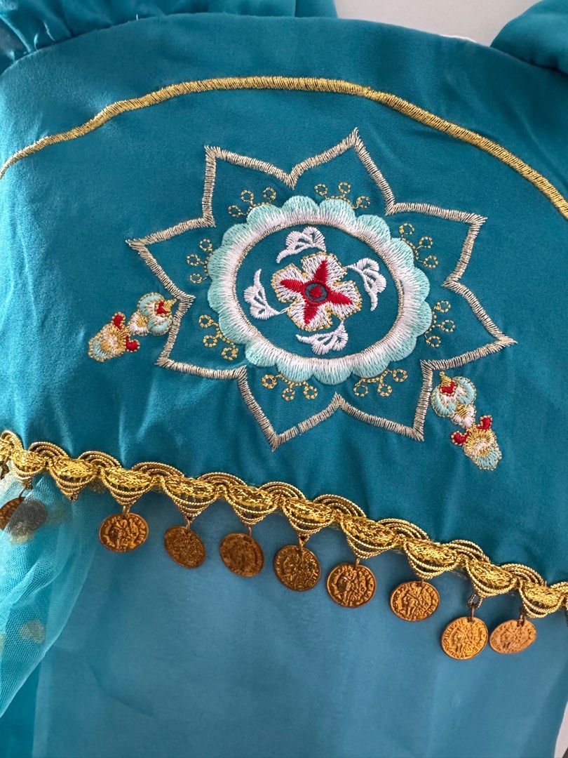 Jasmine Costume - Size 3-5YO (Category: Babies & Kids Fashion) located in Singapore. Submitted by ladyshops (Listing ID 1377980708, Image 2). Description: Condition: 9/10 Almost perfect condition! Size 3-5YO Selfcollect at 670532 or bukit panjang plaza Postage +$3 Adorable Jasmine costume, perfect for dress-up or Halloween! Features a beautiful teal color with gold accents and coin details. The top has intricate embroidery and a comfortable, stre