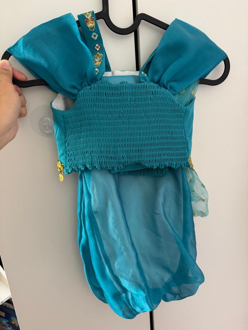 Jasmine Costume - Size 3-5YO (Category: Babies & Kids Fashion) located in Singapore. Submitted by ladyshops (Listing ID 1377980708, Image 3). Description: Condition: 9/10 Almost perfect condition! Size 3-5YO Selfcollect at 670532 or bukit panjang plaza Postage +$3 Adorable Jasmine costume, perfect for dress-up or Halloween! Features a beautiful teal color with gold accents and coin details. The top has intricate embroidery and a comfortable, stre