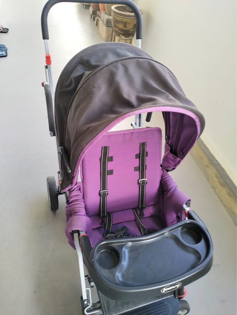 Joovy Caboose Ultralight Stroller - Purple (Category: Strollers) located in Singapore. Submitted by q8jxcskyhy05248 (Listing ID 1378026205, Image 1). Description: Used Joovy Caboose Ultralight stroller. Features a purple seat and canopy. Includes a tray with cup holders. Shows signs of use, but still functional. Great for parents with multiple children. Folds for easy storage..