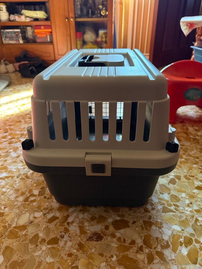 Pet Crate - Grey and Black LxWxH 46x30x30 (Category: Homes & Other Pet Accessories) located in Singapore. Submitted by yvonnelimu (Listing ID 1378046042, Image 2). Description: Durable pet carrier in good condition. Features a secure latch and ventilation slots for your pet's comfort. Suitable for small to medium-sized pets. Easy to clean and transport..
