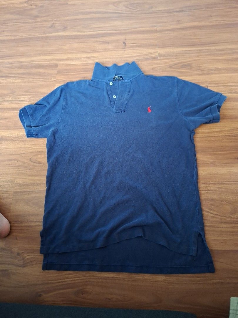 Polo Ralph Lauren Classic Fit Polo Shirt (Category: Tshirts & Polo Shirts) located in Singapore. Submitted by maximillianyeo1 (Listing ID 1378038787, Image 1). Description: - Polo Ralph Lauren polo shirt - Color: Blue - Features iconic red polo player logo - Size: M - Condition: Good (signs of wear) - Ideal for casual wear.
