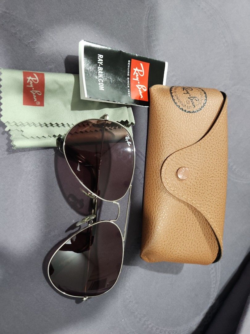 Ray-Ban Aviator Sunglasses - Silver Frame (Category: Babies & Kids Fashion) located in Singapore. Submitted by jenn381 (Listing ID 1378096533, Image 2). Description: - Authentic Ray-Ban Aviator sunglasses - Silver frame - Lenses in excellent condition - Includes original case - Includes cleaning cloth - Includes documentation - Perfect for everyday use.