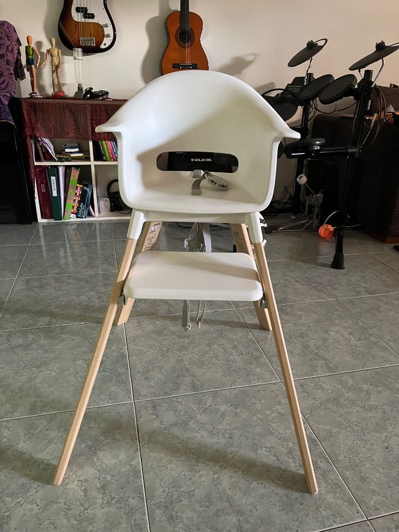 Stokke CLIKK baby High Chair - White (Category: Baby High Chairs) located in Singapore. Submitted by thalie88 (Listing ID 1378075916, Image 2). Description: - Stokke CLIKK baby high chair (315sgd new) - Very Good condition - Includes baby set and tray - White chair with wooden legs - Comes with a grey placemat - Easy to clean - include grey Travel bag (55sgd new).