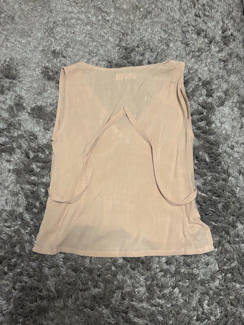 Tie top v-neck from Kalie & Co. (Category: Sleeveless) located in Manila. Submitted by pauly2112 (Listing ID 1378062555, Image 2). Description: Beige tie/ribbon top from local ph brand Kalie & Co. Unused, originally sold for 1495php rfs: doesn’t fit/decluttering flaws: none m.o.p.: Gcash delivery: Lalamove (buyer will shoulder sf).