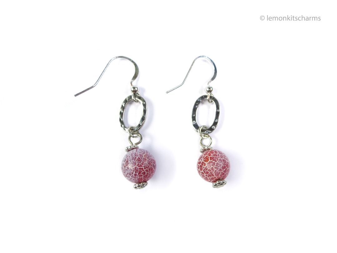 Vintage 1990s Red Crackled Glass Dangling Earrings, er2667-ci (Category: Earrings) located in Singapore. Submitted by lemonkitscharms (Listing ID 1378138153, Image 1). Description: Vintage 1990s - Y2K Red Crackled Glass Dangle Earrings, for pierced ears. Good condition, slight copper base showing on one of the hooks and the loops from wear. Silvertone with oval hammered metal ring, and what looks to be a glass bead with a white crackled effect. P