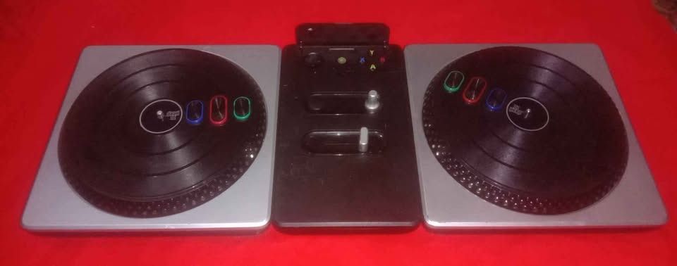 Xbox 360 Dj Hero (Category: Controllers) located in Quezon City. Submitted by potfishcake (Listing ID 1377990827, Image 2). Description: DJ Hero primarily simulates turntablism, a musical style used by disc jockeys to create a new mashup song by incorporating one or more previously recorded songs played on record players along with sound effect generators. The game features score attack gameplay similar to the Guitar Hero games. The controller co