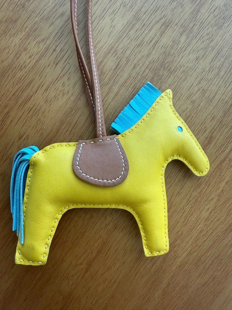 Authentic Hermes Rodeo Horse Bag Charm (Category: Luxury Accessories) located in Quezon City. Submitted by breakmyfashion (Listing ID 1379828382, Image 1). Description: Features a vibrant yellow body with blue mane and tail. Includes a brown leather strap. A charming accessory to elevate your handbag. .