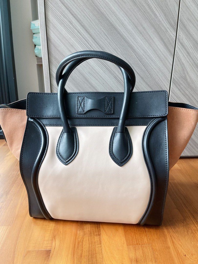 Celine Luggage Handbag - Black, White, and Tan (Category: Bags & Wallets) located in Singapore. Submitted by travislive12 (Listing ID 1379854520, Image 3). Description: Authentic Celine Luggage handbag in excellent condition. Features a tri-color design with black, white, and tan suede sides. Includes a top handle and a front zipper pocket. A stylish and versatile bag for everyday use..